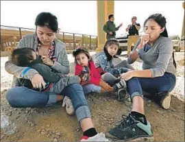  ?? Carolyn Cole Los Angeles Times ?? LUCERO GERARALD, left, and Darlene Perez with their children in El Paso. Several migrant children have died of the f lu in federal custody in the last year.