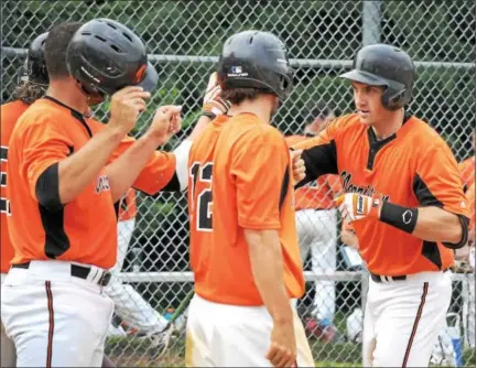  ?? GENE WALSH — DIGITAL FIRST MEDIA ?? Norristown’s Bryan Mulhern celebrates his grand slam with teammates during a playoff game against Trooper.