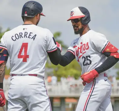  ?? GERALD HERBERT/AP ?? The Twins’ Byron Buxton, right, is greeted by Carlos Correa after his solo homer during a spring training game against the Yankees on March 9 in Fort Myers, Fla.