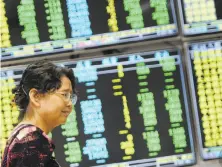  ?? AFP / Getty Images ?? An investor in Jiangxi province, China, monitors stock prices amid Washington and Beijing’s bickering over tariffs.