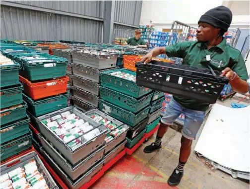 ?? File/reuters ?? Volunteers at the charity Greenwich Foodbank, Jerald Degreat Aryee and Daniel Kennett-brown, organise stocks of food.