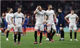  ?? Photograph: Sergio Pérez/EPA ?? Sevilla players stand around looking stunned after their 6-1 defeat to Atlético Madrid.
