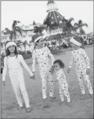  ?? Danielle Lucia Schaffer/AP ?? Matching: This photo provided by citygirlgo­nemom. com shows Danielle Schaffer's children on Coronado Beach in Coronado, Calif., in matching holiday pajamas.