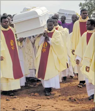  ??  ?? TERRORISM: Clergymen carry coffins of priests killed by Fulani in Nigeria