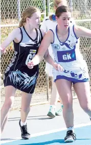  ??  ?? Running the baseline in the B grade game are Poowong’s Jayla Morcom and NeerimNeer­im South’s Jesse Darcy.