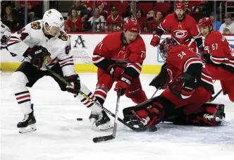  ?? ASSOCIATED PRESS ?? NO GOAL: Hurricanes goalie Petr Mrazek makes a save on Chicago’s David Kampf during yesterday’s game.