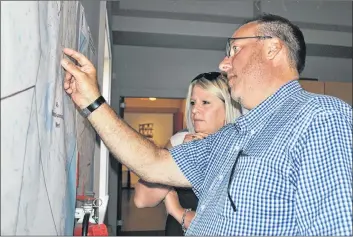  ?? KATHY JOHNSON PHOTO ?? Argyle Barrington MLA Chris d’Entremont and Queens-Shelburne MLA Kim Masland look at the electoral boundary map that proposes to restore the riding of Shelburne County, and would create a new riding of Queens-Lunenburg West, at the provincial Electoral Boundaries Commission review hearing in Shelburne on Sept. 7.