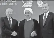  ?? AP/Presidenti­al Press Service ?? Iran’s President Hassan Rouhani, centre, flanked by Russia’s President Vladimir Putin, left, and Turkey’s President Recep Tayyip Erdogan, pose for photograph­s Friday in Tehran, Iran. The three leaders began a meeting to discuss the war in Syria.