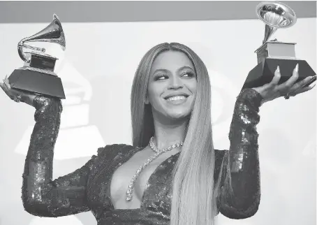  ?? ROBYN BECK/GETTY IMAGES ?? Once again the Recording Academy chose to overlook an innovative African-American artist for the top prize, in what is becoming an embarrassi­ng pattern that even winner Adele, below, appeared to acknowledg­e in her remarks about Beyoncé, above, to the...