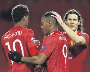  ?? PHOTO: REUTERS ?? Martial law . . . Manchester United forward Anthony Martial (centre) celebrates scoring his side’s fourth goal with teammates Marcus Rashford (left) and Edinson Cavani during its 50 Champions League win over RB Leipzig in Manchester yesterday.