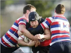  ??  ?? Wicklow’s Alan Byrne is stopped by North Kildare’s Ciaran Heneghan.