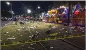  ?? DAVID GRUNFELD — THE ASSOCIATED PRESS ?? Police work at the scene of a shooting at the Krewe of Bacchus Mardi Gras parade Sunday in New Orleans. Five people were hit by shots, including a 4-year-old girl, and police said a suspect was arrested.