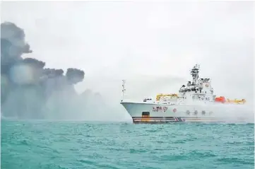  ??  ?? This handout from China’s Transport Ministry taken and released shows the Chinese firefighti­ng vessel ‘DONGHAIJIU 117’ spraying water on the burning oil tanker Sanchi at sea off the coast of eastern China. — AFP photo