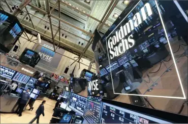  ?? PHOTO: AP ?? In this file photo a lighted sign marks the Goldman Sachs trading post on the floor of the New York Stock Exchange. The company reported a 49 percent decline in profits in its quarterly financial results yesterday.