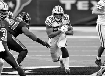  ?? AP Photo/Sam Craft ?? Green Bay Packers running back AJ Dillon (28) runs with the ball as Houston Texans defensive end Carlos Watkins (91) defends during the first half of an NFL football game on Sunday in Houston.