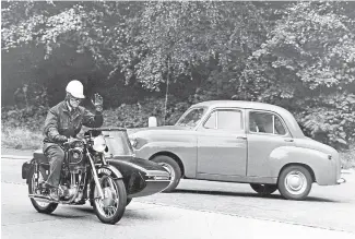  ?? ?? A sidecar rider makes his intentions of going straight on crystal clear to the driver of the emerging saloon car on his left – another photo from Mortons Archive.