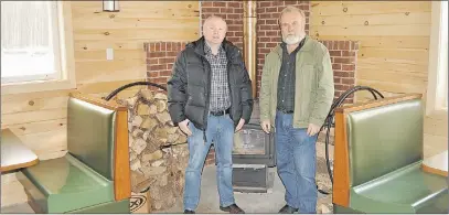  ?? ADAM MACINNIS/THE NEWS ?? John Charlton, chair of the building project, and Allison Munro, president of the Pictou County Snow Riders, stand in the social area of their new clubhouse.