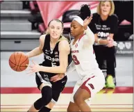  ?? Michael Woods / Associated Press ?? UConn guard Paige Bueckers (5) drives against Arkansas defender Makayla Daniels during the second half in January.