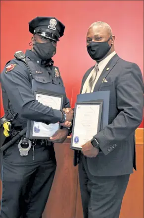  ?? DANIELLE RAY / SENTINEL & ENTERPRISE ?? Fitchburg Police Officer James McCall and the Rev. Thomas Hughes shake hands after being recognized as honorees of the Black and Latino Caucus’ 2021 Black Excellence on the Hill on Friday.