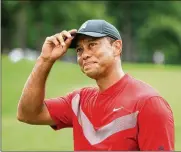  ?? ANDREW REDINGTON / GETTY IMAGES ?? Tiger Woods reacts after finishing on the 18th green in the final round of the BMW Championsh­ip on Sunday in Medinah, Illinois.