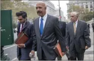  ?? MARY ALTAFFER - ASSOCIATED PRESS ?? Ted Wells, Jr., center, the lead attorney for Exxon, leaves Manhattan Supreme court after opening arguments in a lawsuit against Exxon on Tuesday in New York.