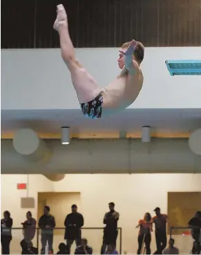  ?? STAFF PHOTO BY ANGELA ROWLINGS ?? A CUT ABOVE: Weston’s Dale Nickerson, who won convincing­ly with a score of 580.80, dives during yesterday’s North championsh­ips at MIT.