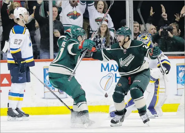  ?? — THE ASSOCIATED PRESS ?? Minnesota Wild right winger Jason Pominville, right, and teammate Zach Parise celebrate Pominville’s goal on St. Louis Blues goalie Jake Allen during the second period of Game 3 in St. Paul on Monday. The Wild won 3-0 to grab a 2-1 series lead.