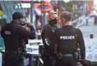  ?? JOE RONDONE/THE COMMERCIAL APPEAL ?? MPD officers wear protective masks as they patrol Beale Street while establishm­ents slowly reopen, part of the city's Phase 1 plan on restarting the economy May 8, 2020.