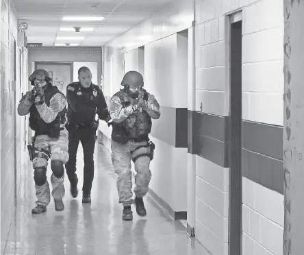  ?? OMAR RICARDO AQUIJE/ AP ?? Law enforcemen­t takes part in a drill at a Hudson Falls, N. Y., school last year.