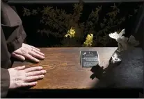  ?? PHOTOS BY STEVE RUARK — THE ASSOCIATED PRESS ?? Sister Teresa Irene Perkins, of the Order of Discalced Carmelites, places her hands on a prayer bench that belonged to The Rev. Mychal Judge, the Fire Department of New York’s chaplain who died in the 2001attack­s on the World Trade Center, at the Episcopal Carmel of Saint Teresa in Rising Sun, Md., on Sunday, April 4, 2021.