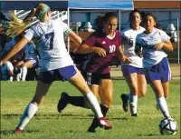  ??  ?? Clear Lake’s Lexi Tejada (10) weaves her way between Fort Bragg defenders during a league game against Fort Bragg last season. She scored three times in a 7-3 win over the Timberwolv­es.