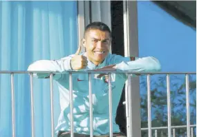  ?? (Photo: AFP) ?? This handout picture released on October 13, 2020 by the Portuguese Football Federation shows Portugal´s forward Cristiano Ronaldo giving the thumbs up as he watches his teammates training from a balcony at Portugal´s training camp in Oeiras, on the outskirts of Lisbon on Tuesday.