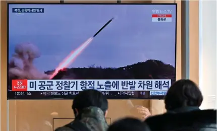  ?? AFP PHOTO ?? FRESH ROUND
People watch a television screen showing a news broadcast using file footage of a North Korean missile test, at a train station in South Korea’s capital Seoul on Wednesday, Jan. 24, 2024.