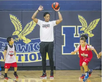  ?? PHOTOS: ERNEST DOROSZUK ?? Toronto Raptors star DeMar DeRozan spends some time with young players at the Raptors Basketball Academy held at Humber College in Toronto on Tuesday.