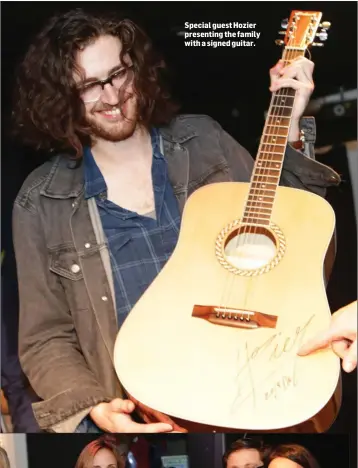  ??  ?? Special guest Hozier presenting the family with a signed guitar.