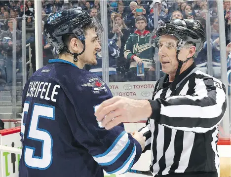  ?? JONATHAN KOZUB/NHLI VIA GETTY IMAGES ?? Linesman Brad Lazarowich, right, chats with Mark Scheifele after the final game of Lazarowich’s career.