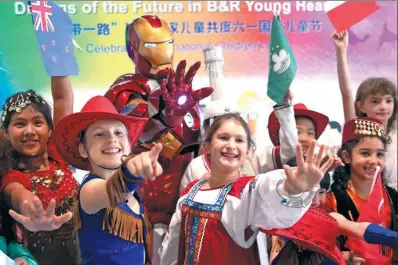  ?? ZOU HONG / CHINA DAILY ?? Children from countries involved in the Belt and Road Initiative pose on Wednesday in Beijing for a photo with comic book hero Iron Man at an event marking Internatio­nal Children’s Day, which falls on Thursday.