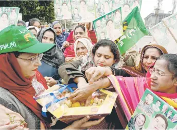  ?? — AFP photo ?? Supporters and activists of Pakistan Muslim League Nawaz (PMLN) party celebrate the appointmen­t of Maryam Nawaz Sharif as chief minister of Punjab province along a street in Lahore.