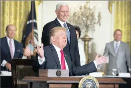  ?? PICTURE: EPA-EFE REUTERS ?? US President Donald Trump prepares to sign a space policy directive; in front of vice-president Mike Pence, centre, secretary of commerce Wilbur Ross, left, and director of the office of management and budget Mick Mulvaney, right, during a meeting of...