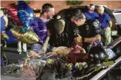  ?? Jason Lee / Sun News via Associated Press ?? Police officers mourn at a memorial in Florence, S.C., after a candleligh­t vigil for Sgt. Terrence Carraway, who was killed in an ambush.