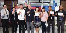  ??  ?? Chairman Corpuz (fourth from left), GM Balutan (third from left) and Human Resources Department manager Roger Ramirez (extreme left) with employees who have been with PCSO for 15 years in the name of public service