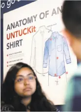  ?? Photos by Noah Berger / Special to The Chronicle ?? Mike Reveland, left, tries on a sports jacket at Untuckit in S.F.’s Marina neighborho­od. Above: Salesperso­n Sabina Thompson speaks with a co-worker at the store, which offers its signature shirts as well as T-shirts, polos and other menswear.