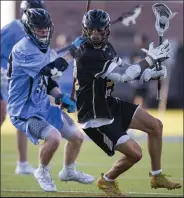  ?? Timothy Hurst
Staff Photograph­er ?? /
Monarch’s Braeden Wimer, right, led the state in points with 71 and was a USA Lacrosse All-american after the 2021 season.