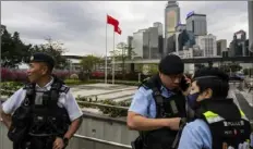  ?? Louise Delmotte/Associated Press ?? Police officers stand guard Tuesday outside the Legislativ­e Council in Hong Kong.