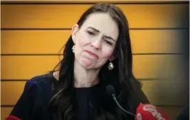  ?? WARREN BUCKLAND/NEW ZEALAND HERALD VIA AP ?? New Zealand Prime Minister Jacinda Ardern frowns Thursday as she announces her resignatio­n at a press conference in Napier, New Zealand. Ardern says that she will not contest this year’s general elections.