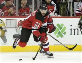  ?? BILL KOSTROUN — THE ASSOCIATED PRESS ?? In this photo, New Jersey Devils right wing Kyle Palmieri (21) passes the puck during the second period of an NHL hockey game against the Colorado Avalanche in Newark, N.J.