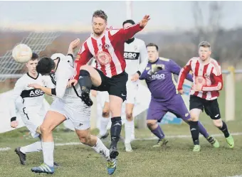  ??  ?? Sunderland West End (red and white) attack against Coxhoe Athletic on Saturday. Pic by Tim Richardson.