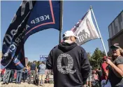  ?? STEPHANIE KEITH Getty Images ?? A person wears a QAnon sweatshirt during a pro-Trump rally in October in New York. QAnon traffics in conspiracy theories.