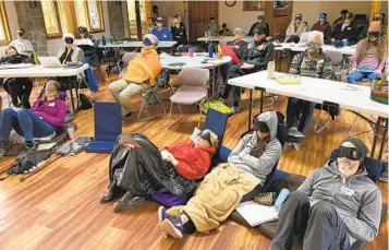  ?? ANDREW SELSKY AP ?? Psilocybin facilitato­r students sit with eye masks on while listening to music during an activity at a training session near Damascus, Ore. They are being trained in how to accompany patients tripping on psilocybin.
