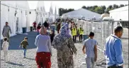  ?? ANDREW HARNIK / ASSOCIATED PRESS 2021 ?? Afghan refugees walk through a refugee camp at Joint Base McGuire Dix Lakehurst, N.J., on Sept. 27, 2021.